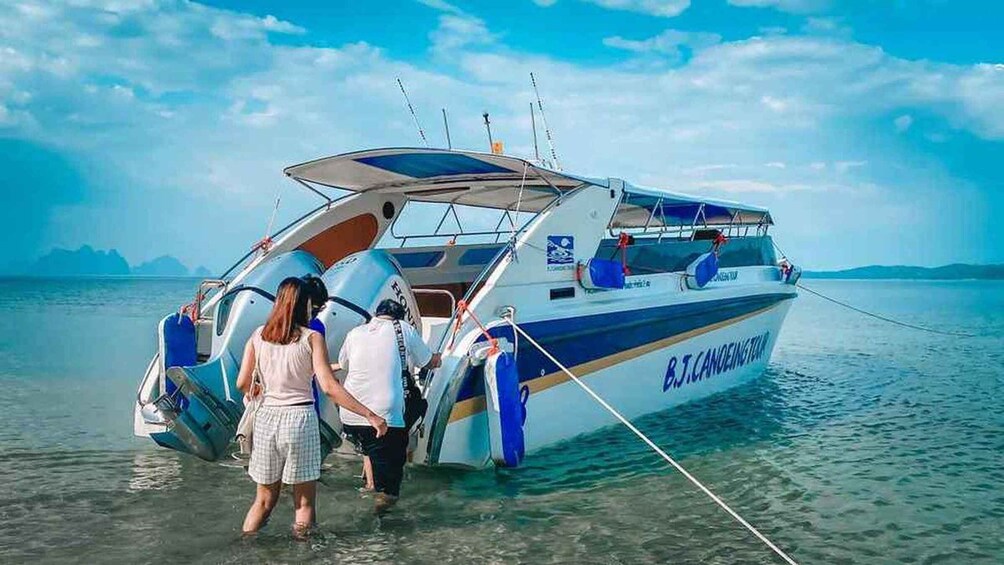 A boat with people boarding it. 4