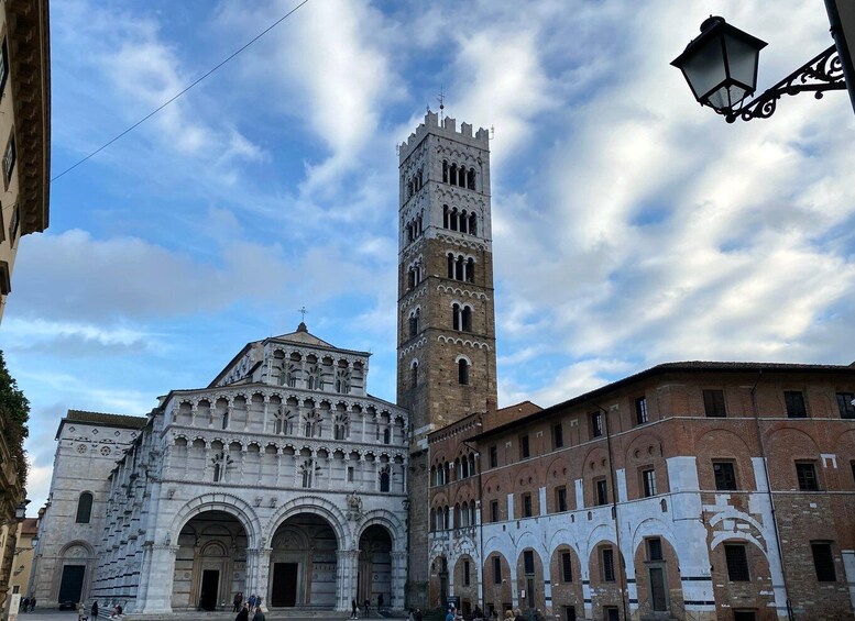 A historic building with a prominent tower and an ornate facade. 2