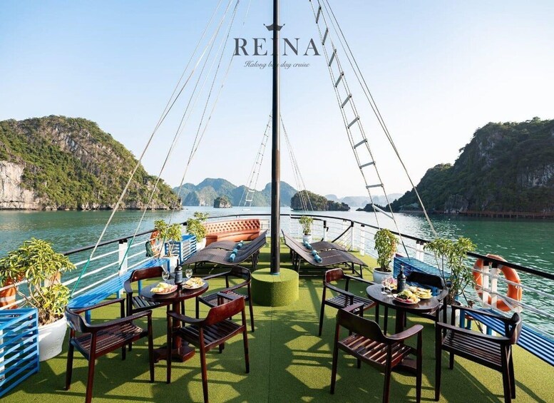 A boat deck with tables and chairs, surrounded by water and greenery. 5