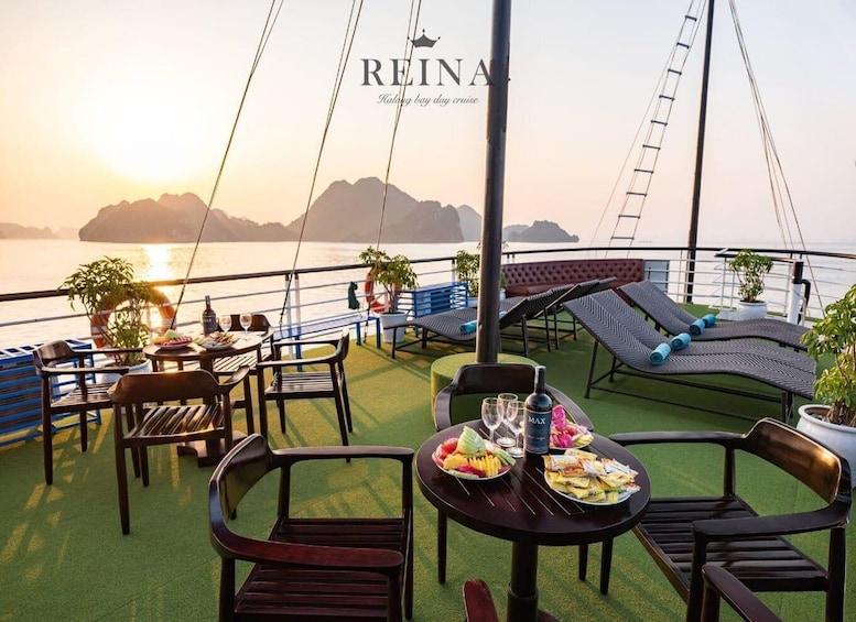 A serene outdoor dining area on a boat with tables, chairs, and lounge chairs. 5