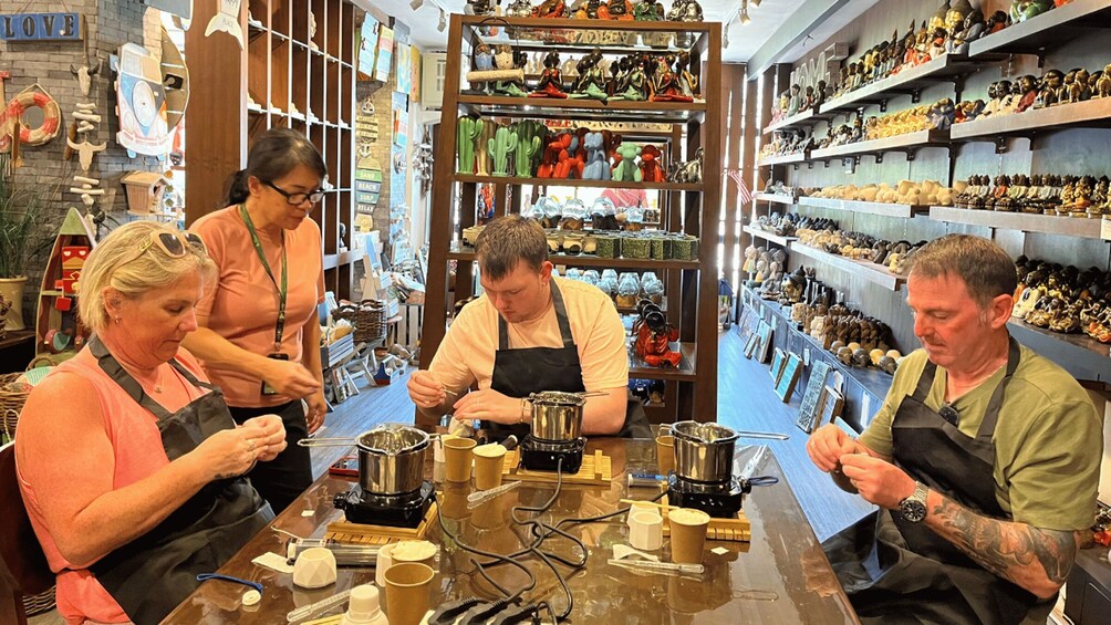 A coffee shop with people preparing drinks. 3