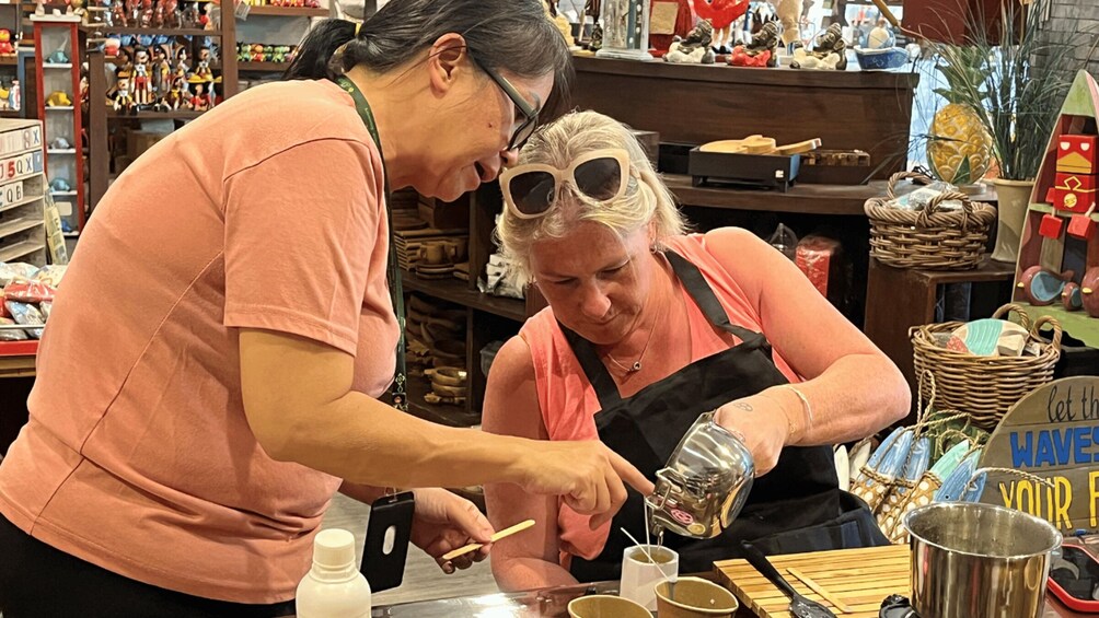 Two people in a store, one holding a bottle and the other holding a spoon. 4