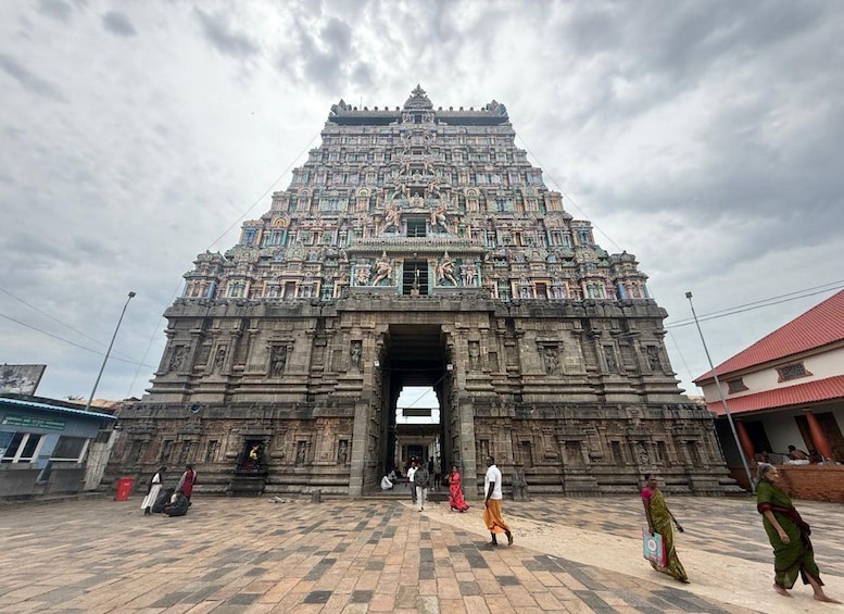 A large, intricately carved temple with a central doorway and multiple tiers. 1