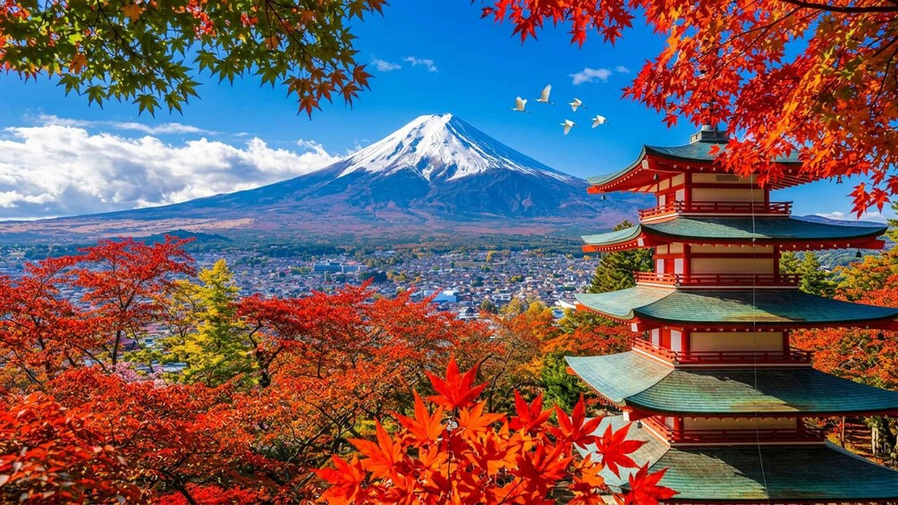 A traditional Japanese pagoda, Mount Fuji in the background, and autumn foliage. 4