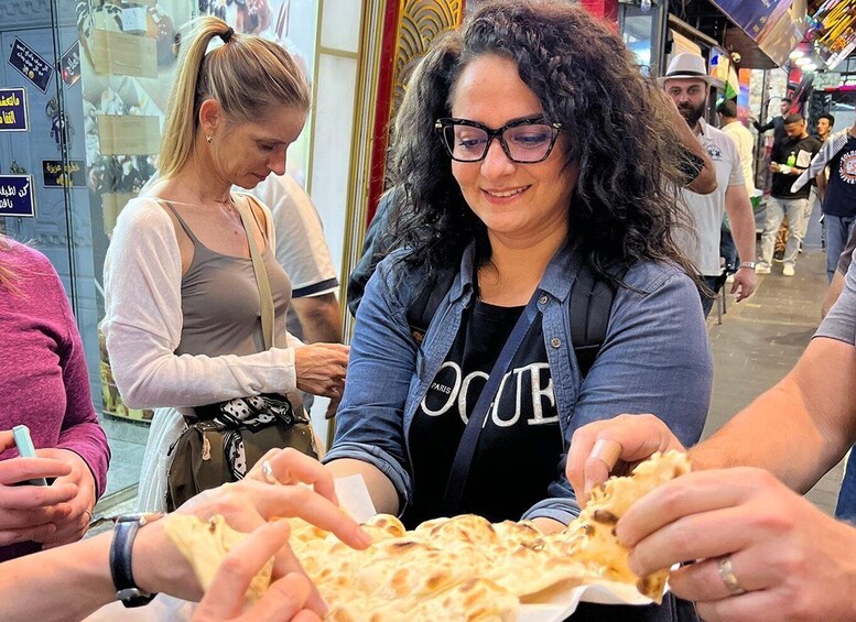 A person holding a flatbread at a market. 5