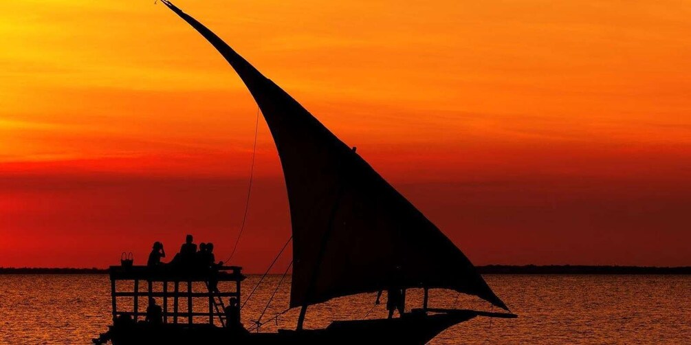 A boat with a sail against a sunset. 2