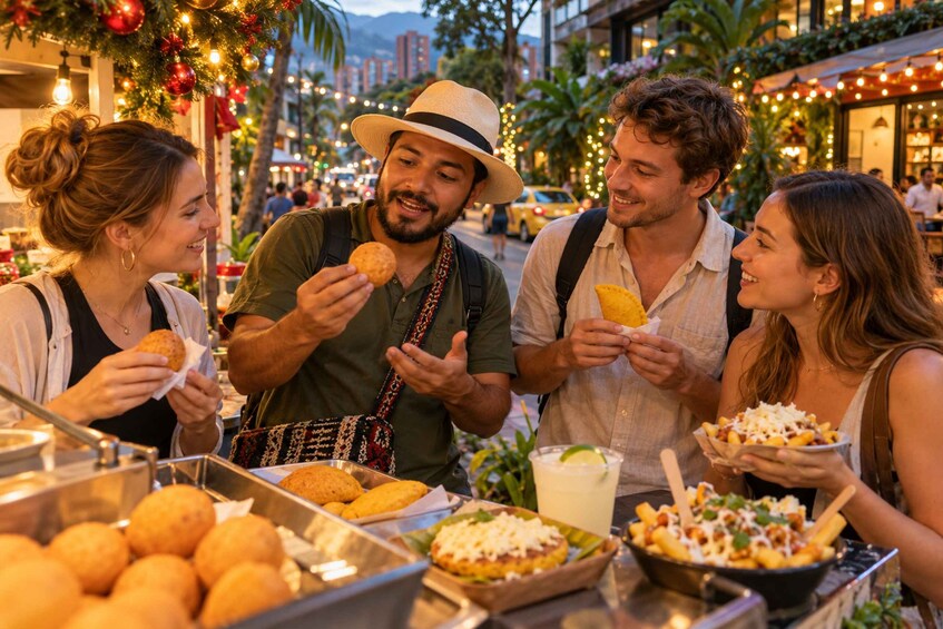 A group of people enjoying food at an outdoor market with festive decorations. 1