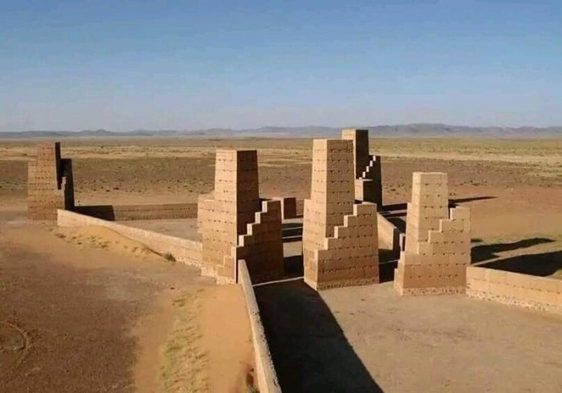 A series of brick structures in a desert landscape. 2