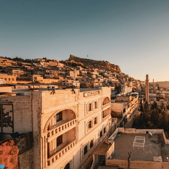 A historic building with arches and a rooftop. 5