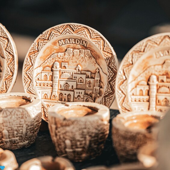 Intricately carved ceramic plates with detailed architectural designs. 2