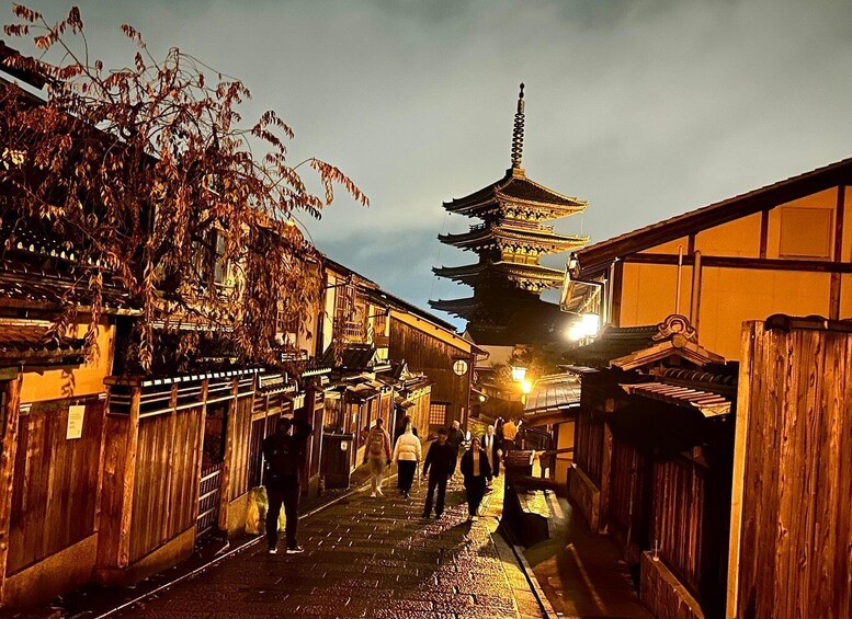 A traditional Japanese street at dusk with a pagoda in the background. 1