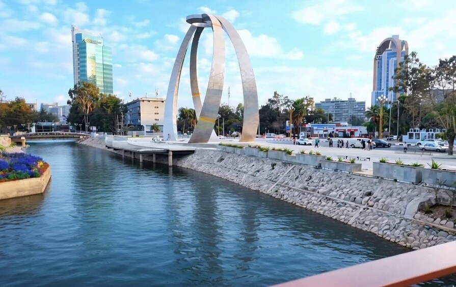 A river with a modern bridge and urban buildings in the background. 4