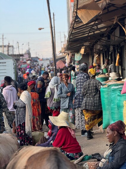 A crowded market with people shopping and vendors selling goods. 5