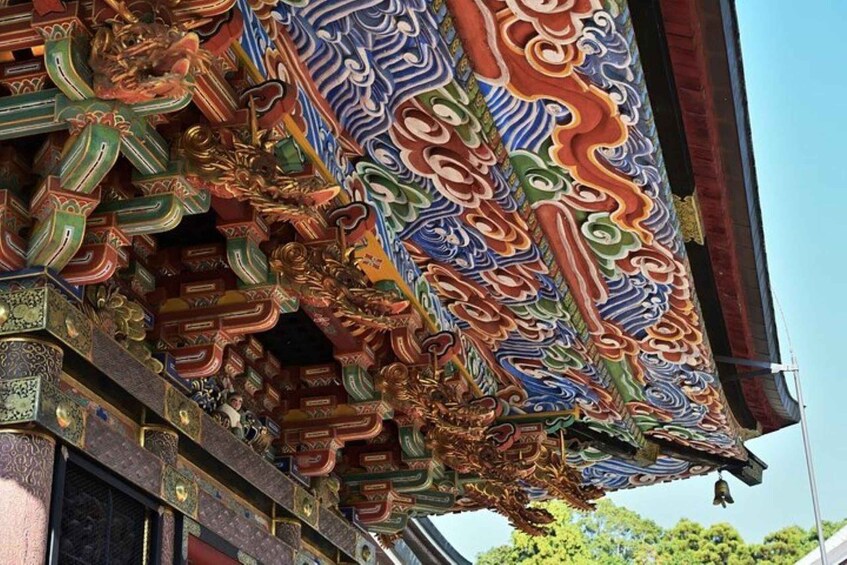 A detailed, colorful temple roof with intricate designs and golden accents. 2