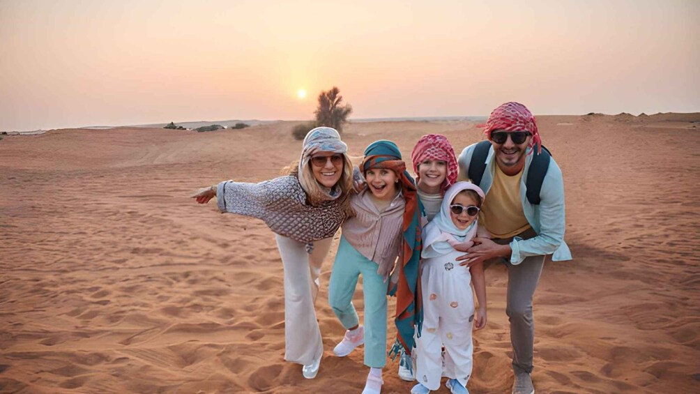 A family of four in a desert landscape at sunset. 2