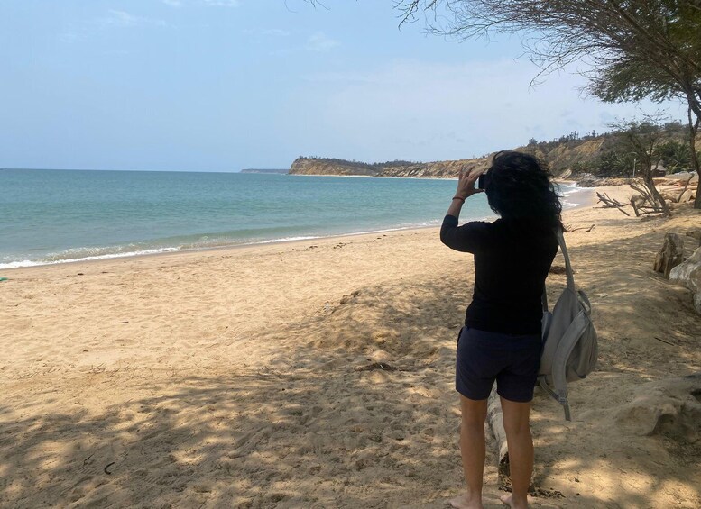 A person taking a photo of the beach and ocean. 3