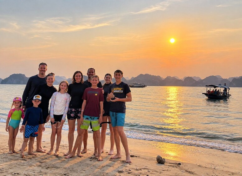 A family on a beach at sunset with a boat in the background. 3