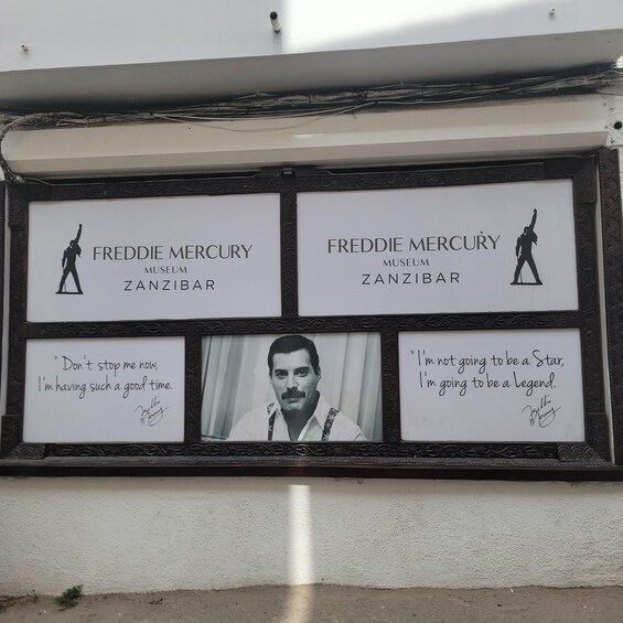 A framed tribute to Freddie Mercury with text and a photo. 1