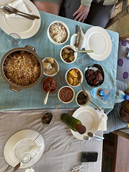 A table with various dishes including rice, meat, and vegetables. 2