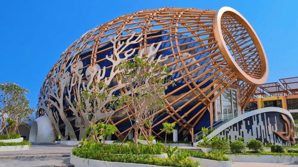A modern spherical building with a bamboo lattice exterior and a blue interior. 5