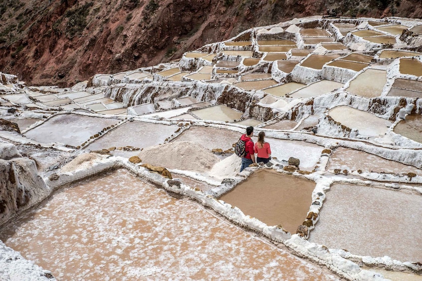 Terraced mineral pools with people standing on the terraces. 4