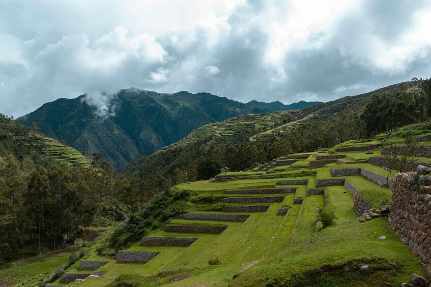 Terraced fields, stone walls, and mountains in the background. 5