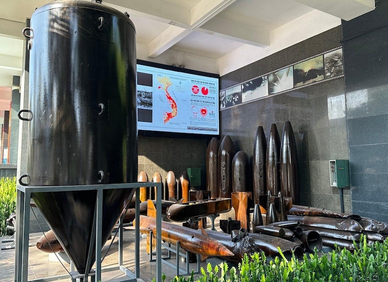 A museum exhibit with industrial artifacts, including a large metal container and various metal objects. 4