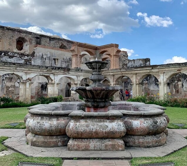 A historic building with a central fountain surrounded by arches. 4