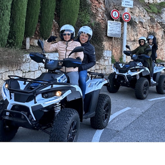 Three people on ATVs on a road with a speed limit sign of 30. 2