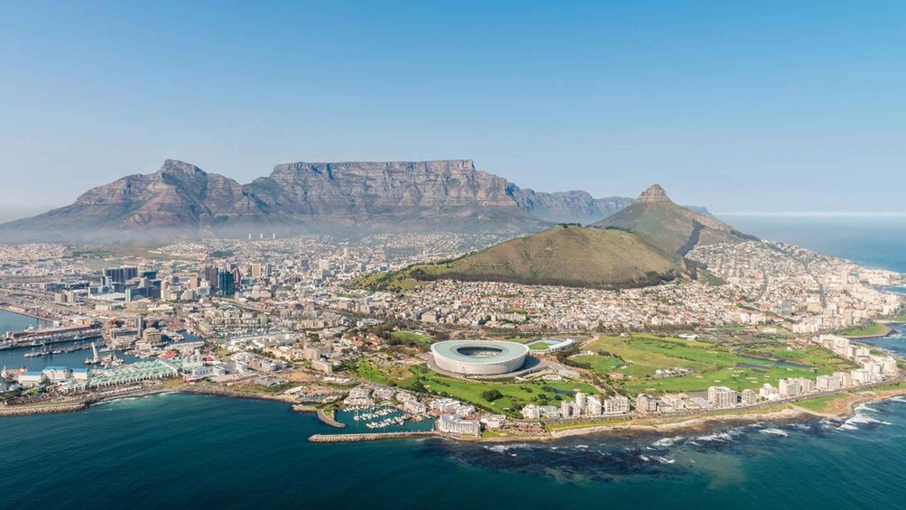 An aerial view of Cape Town, South Africa, featuring Table Mountain, the cityscape, and the V&A Waterfront. 3