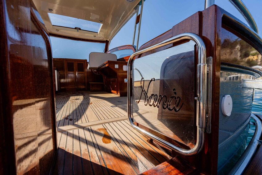 A wooden deck with a glass door marked "Nanaimo" and a view of water. 3