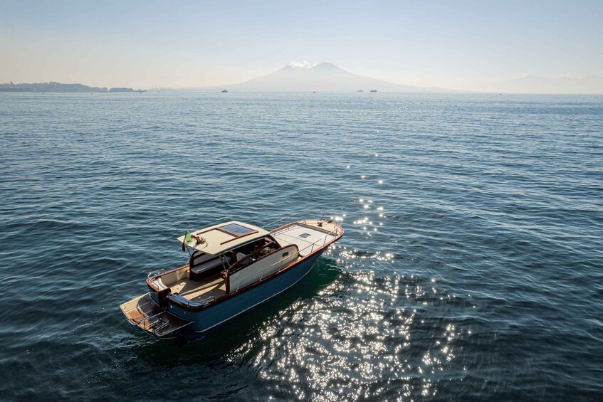 A boat on calm water with a mountain in the background. 4