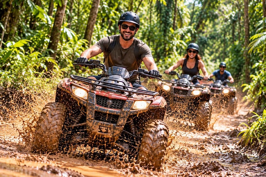 People riding ATVs on a muddy trail in a forest. 4