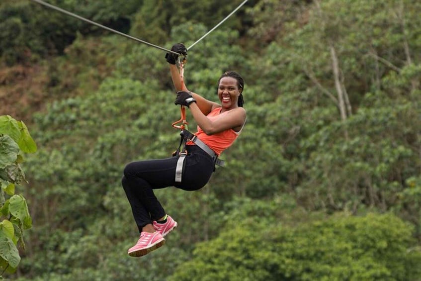 A person zip-lining through a forested area. 5