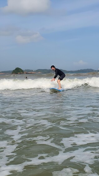 A person surfing on a wave in the ocean. 2