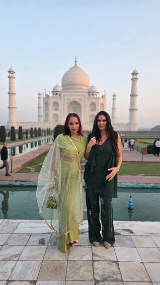 Two people standing in front of the Taj Mahal. 4