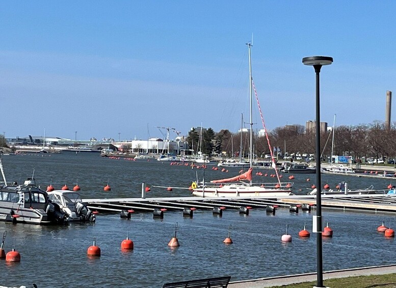 A marina with boats, buoys, and a crane in the background. 5