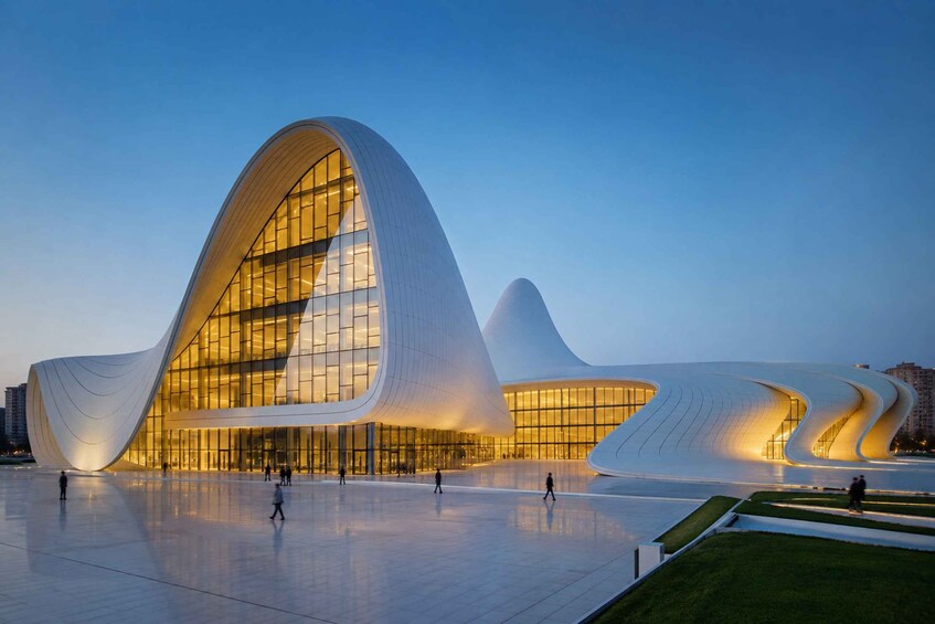 A modern architectural building with a unique curved design, surrounded by a spacious plaza. 5