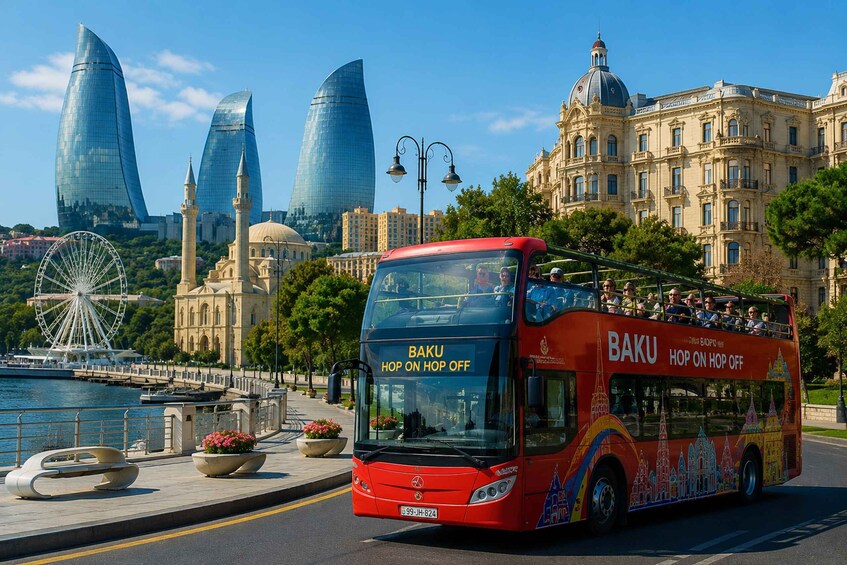 A red double-decker bus with 'BAKU HOP ON HOP OFF' on the front, driving on a city street with historic buildings and a Ferris wheel in the background. 4