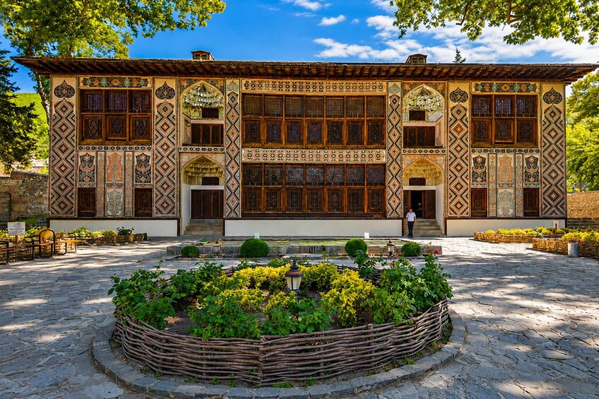 A traditional building with intricate tile work and a courtyard with a fountain. 2