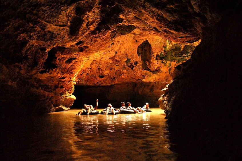 People floating in a cave with a warm light. 5