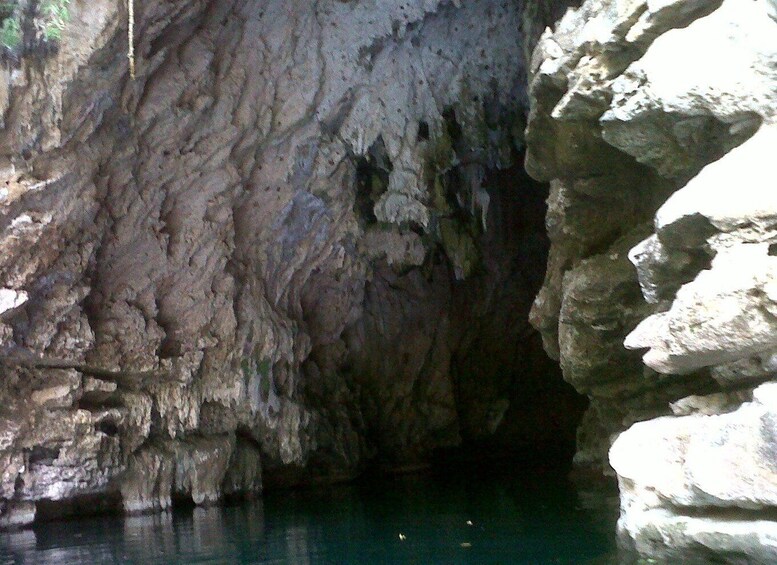 A cave entrance with water at the bottom. 5