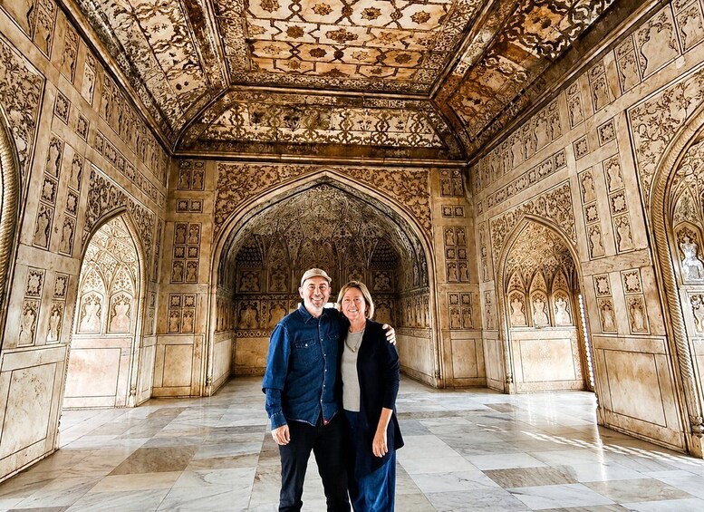 An ornate interior with intricate tile work and arched doorways. 3