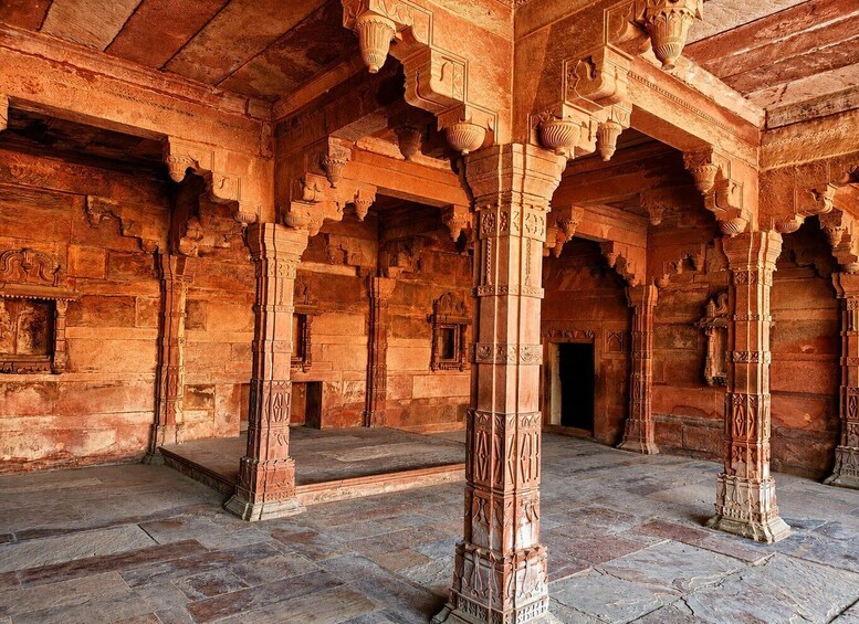 An ancient architectural structure with ornate pillars and detailed carvings. 4