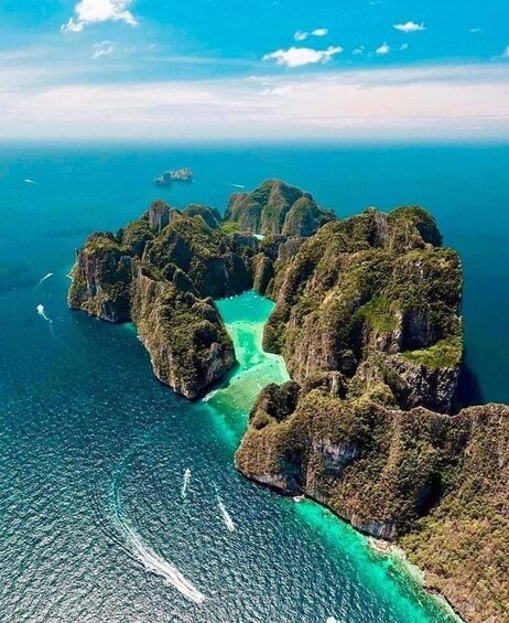 A coastal landscape with rugged cliffs and turquoise waters. 4