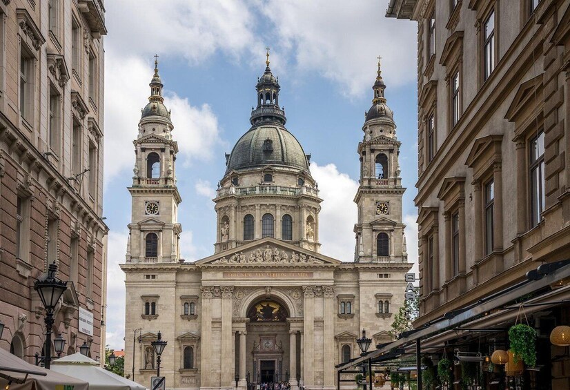 A grand historical building with a large dome and two bell towers. 2