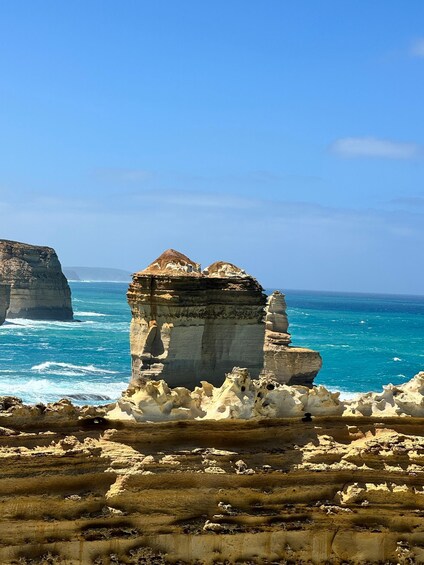 A coastal landscape with prominent rock formations and cliffs. 1