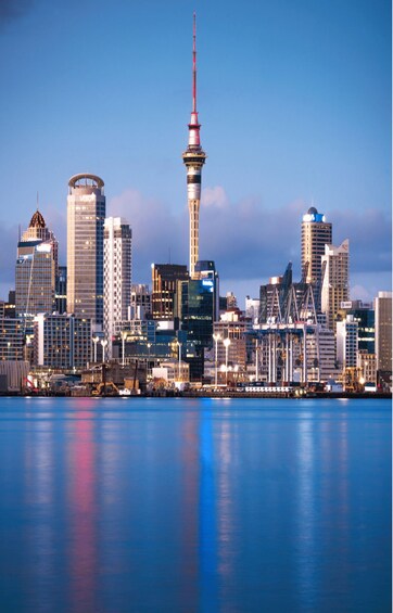 A city skyline with a prominent tower and various modern buildings. 3