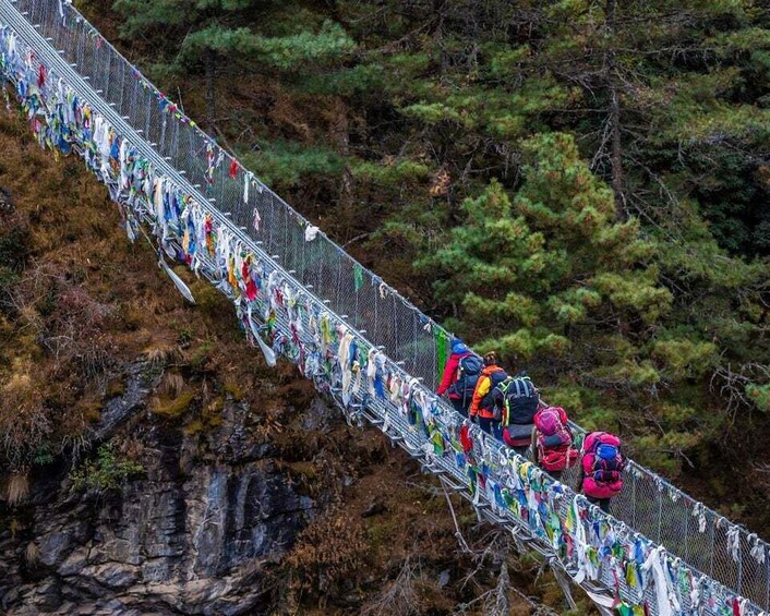 A suspension bridge with colorful prayer flags. 4