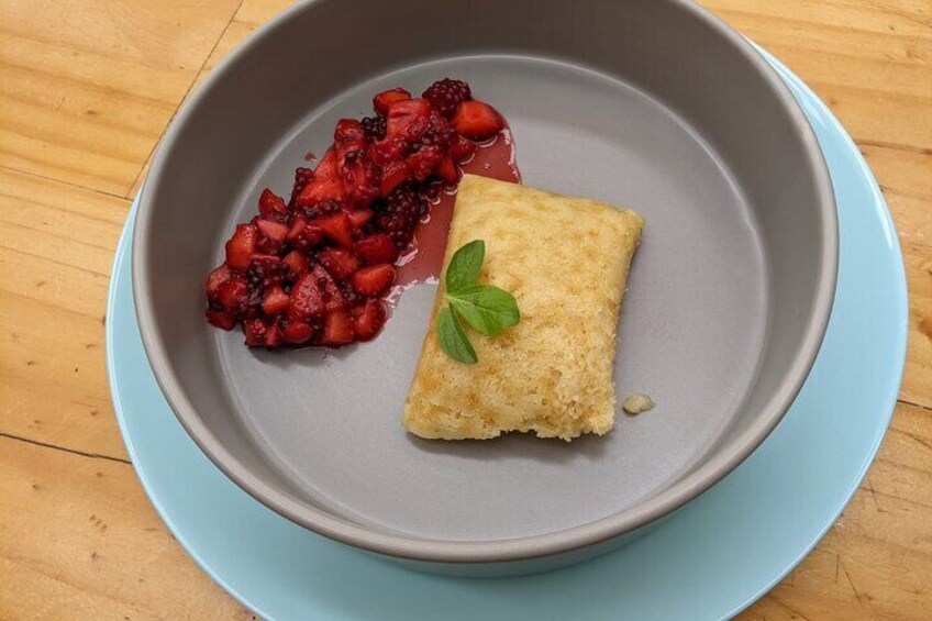 A dessert plate with a square pastry and a side of fresh berries. 5